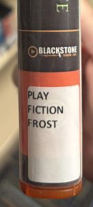 A closeup of the spine on the audiobook "Halfway to the Grave," focusing on the spine label. The spine label reads "PLAY FICTION FROST."