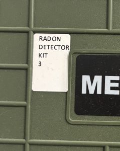 A closeup of the top of a radon detection kit from the company Meijia, focusing on the spine label given to it. The spine label reads "RADON DETECTOR KIT 3."