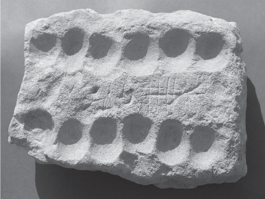 A white clay tablet with shallow divets