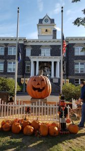 image of a large jack o lantern in the center of a town square