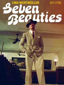 Poster for Seven Beauties. Psoter shows a man standing in a bar wearing a suit and brimmed hat. 